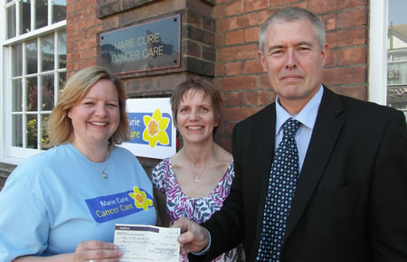 Yvonne Kidd receives the cheque for £2,500 from Donna and Stephen Gristwood