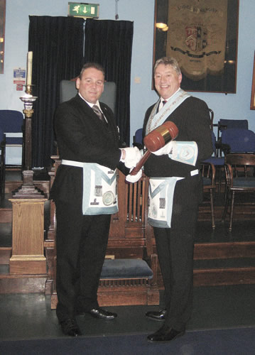 WBro Jonathon Hibbins claims the Travelling Gavel from WBro Jeremy Sanders, Worshipful Master of Horsa Lodge in Bournemouth in February 2011