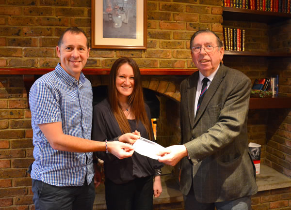 Helping Hands trustees Ian Spencer and Claire Lister receive the £5,000 cheque from WBro Roly Scotney