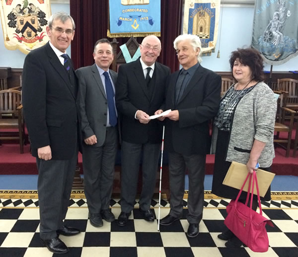 RWBro Max Bayes, Provincial Grand Master presents the £25,000 cheque to Andy Shipp, DeafBlind UK Digital Inclusion volunteer - accompanied by Jeff Skipp, Chief Executive, Monica Evans, Senior Institutional Fundraiser & WBro Gerry Crawford, Provincial Grand Charity Steward