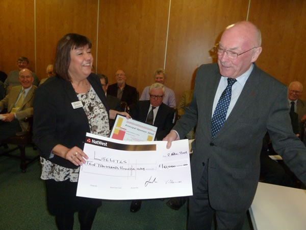 Provincial Grand Master, RW Bro Max Bayes presents the £10,000 cheque to Lifelites CEO, Simone Enefer-Doy