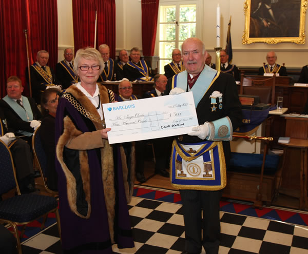 Stamford Town Mayor, Councillor Mrs Susan Sandall, receives the cheque for her charity fund from WM, WBro David Stimson